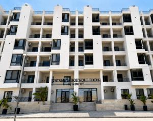 an exterior view of a white building at Settle inn Jebal apartments in Cairo
