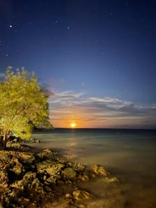 a view of the ocean at night with the moon at Pousada Nascente do Sol in Ilha de Boipeba