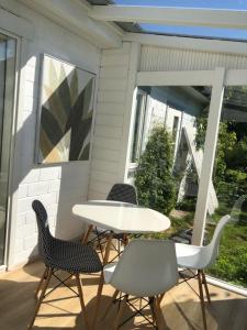 a patio with a table and chairs on a porch at Aavik Apartment in Kuressaare