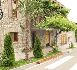 a stone house with trees in front of it at Guest House 52 in Goris