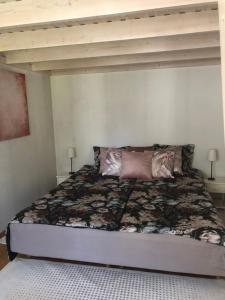 a bedroom with a large bed with two lamps at Aavik Apartment in Kuressaare