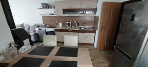 a small kitchen with a sink and a refrigerator at Chaloupka v srdci památkové zóny in Putím