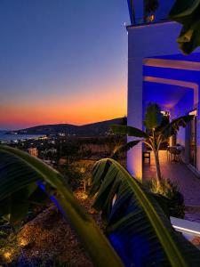 a house with a view of the ocean at sunset at Vila Alexandros in Qeparo