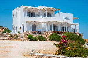 a large white house on a beach at Studios Poulati in Artemonas
