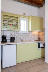a kitchen with lime green cabinets and a sink at Studios Poulati in Artemonas +14 photos