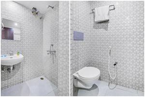 a white bathroom with a toilet and a sink at FabHotel Aqua Pearl Inn in Navi Mumbai