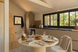 a kitchen with a table with a bowl of fruit on it at Studio avec jardin à 2 min à pied de la plage du Moulleau in La Teste-de-Buch