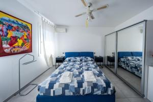 a room with two beds and a ceiling fan at B&B We CaRe Appartamento in Lendinara