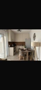 a kitchen with a table and chairs and a kitchen with a refrigerator at Soleil House Thassos in Kallirákhi