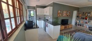 a kitchen with a counter and a tv in it at Executive Flat with Stunning Views in Westville