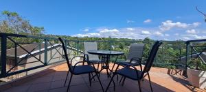 a balcony with a table and chairs on a deck at Executive Flat with Stunning Views in Westville