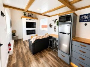 a small kitchen and dining area of a tiny house at Zion Couples Retreat Romantic Desert Tiny Home in Apple Valley