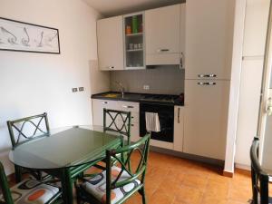 a small kitchen with a glass table and a stove at Residenze Sant'Andrea in Isca Marina +24 photos