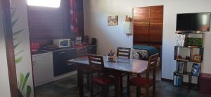 a kitchen and dining room with a table and chairs at Le Papyrus in Cilaos