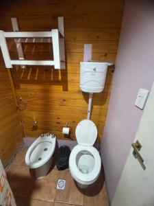 a small bathroom with a toilet and a sink at Cabañas las fulanas in Villa Giardino +15 photos