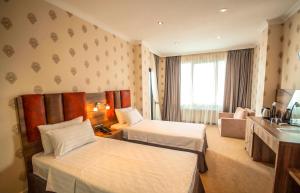 a hotel room with two beds and a window at Hotel Montana in Sarpi