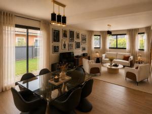 a living room with a glass table and chairs at Villa Confidentielle Opale in Merlimont