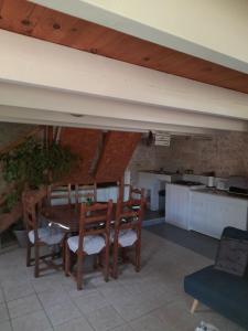 a kitchen and dining room with a table and chairs at Maison Vacances in Saint-Savinien