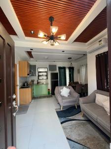 a living room with a couch and a ceiling at Modern Home and Stylish Design in Ibaba