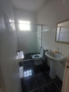 a bathroom with a toilet and a sink at Mezanino 131 in Ouro Preto