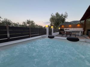 a swimming pool in a backyard with a table at Emerald Dream Oasis Studio in Skala Potamias
