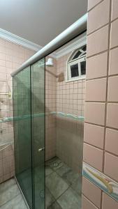 a glass shower in a bathroom with a window at Encantos do Mar Hostel in Recife +28 photos