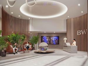 a lobby with people sitting in chairs and a large orb at BW Perla - Premium Apartments in Belgrade