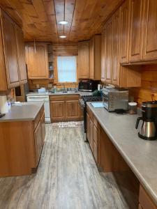 a kitchen with wooden cabinets and a counter top at Private with a Beautiful View House in Afton