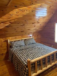 a bedroom with a bed in a log cabin at Private with a Beautiful View House in Afton