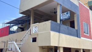 a building with a sign on the side of it at Golden Waves Guest House in Mahabalipuram