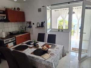 a kitchen with a table with a table cloth at Romantic Apartment Sonja, Beachfront in Cesarica