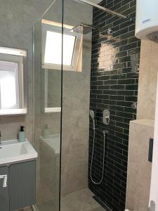a bathroom with a glass shower and a sink at Premium apartments in Ulcinj +51 photos
