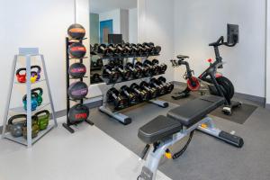a gym with several exercise bikes and weights at Homewood Suites by Hilton Bonita Springs, FL in Bonita Springs