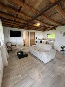 a large room with a bed and a television in it at Hospedaje Finca Eje Cafetero, Casa Ne u in Marsella
