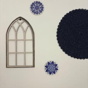 a picture of a window and plates on a wall at Greek Home4 in Al Khobar
