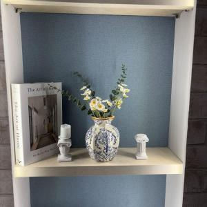 a blue and white vase with flowers on a shelf at Greek Home4 in Al Khobar
