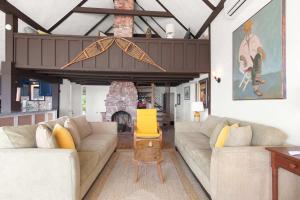 a living room with two couches and a fireplace at Beachfront on Commercial St Dog Friendly in Provincetown