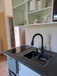 a kitchen counter with a sink and a sink at Studio sisco in Sisco