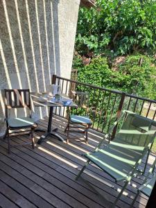 a patio with two chairs and a table on a deck at Studio sisco in Sisco