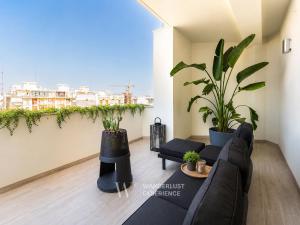 a living room with a couch and potted plants at Wanderlust Experience Zenith Rooftop in Bitonto
