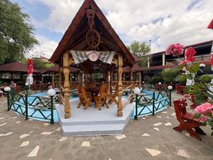 a carousel in a park with a building at Marevento Hotel in Costinesti +23 photos