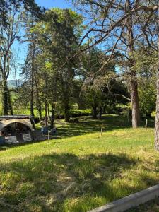 a park with a bridge and trees and grass at Havre de paix in Cluny