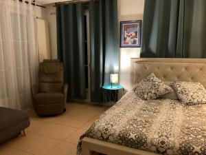 a bedroom with a bed and a chair at Havre de paix in Cluny