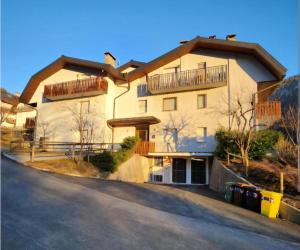 a large white building with balconies on top of it at Nuvola in Ravascletto