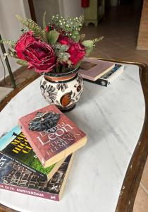 a table with a vase of flowers and a book at Tenuta Il Tresto in Poggibonsi