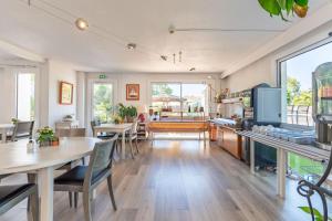 a kitchen and dining room with tables and chairs at Hôtel Le Parasol in Ars-en-Ré