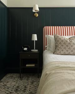 a bedroom with a bed and a table with a phone at Domaine Golf Saint-Lazare in Limoges +29 photos