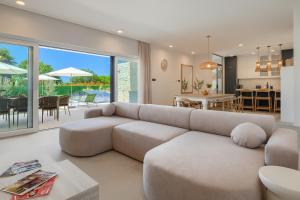 a living room with a couch and a dining room at Villa Dell Arte in Žminj