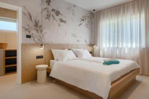 a bedroom with a large white bed and a window at Villa Dell Arte in Žminj +41 photos