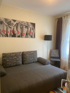 a bedroom with a bed and a painting on the wall at SV Appartamenty in Horten